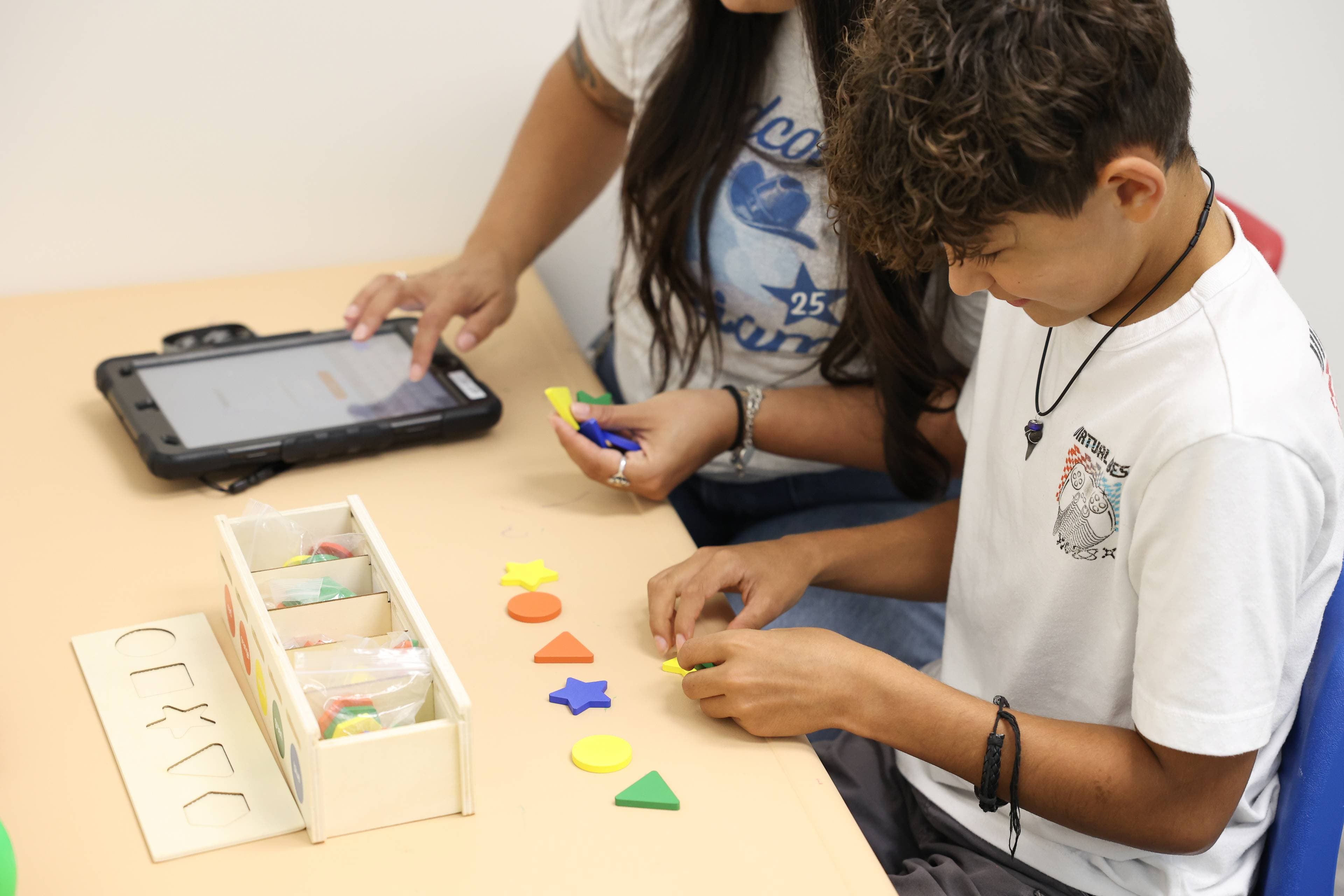 Young learners participating in ABA therapy session with colorful materials